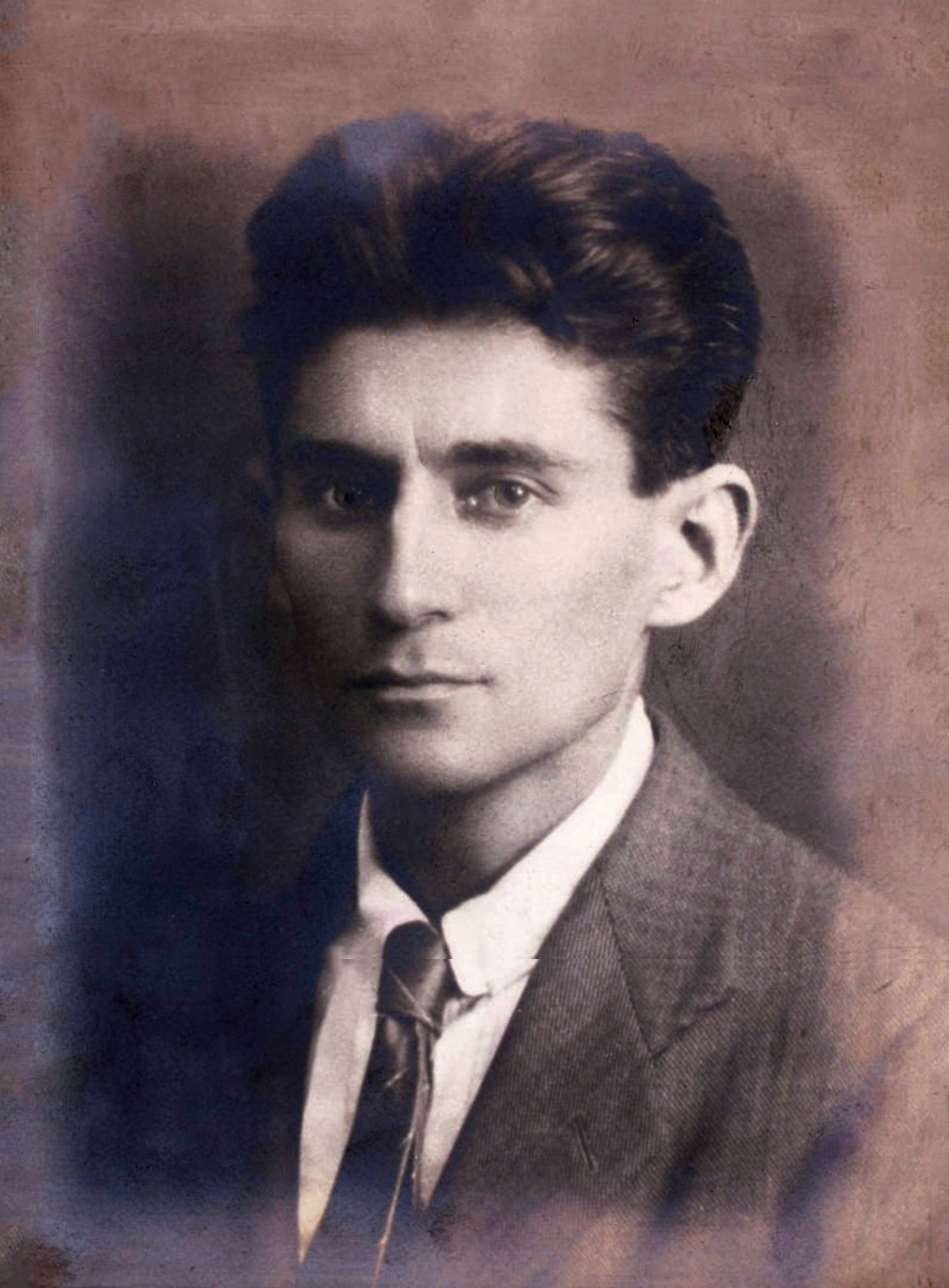 Black/white photo of Franz Kafka with purplish, bluish discoloration